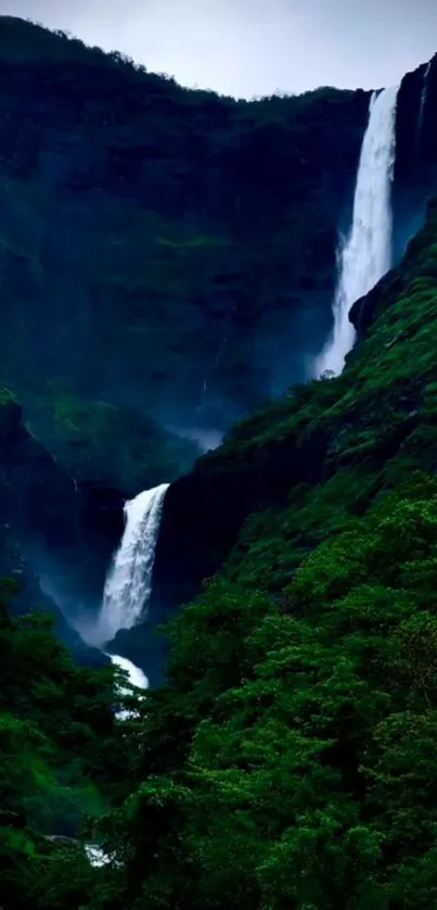 Serene waterfall in a lush green valley landscape.