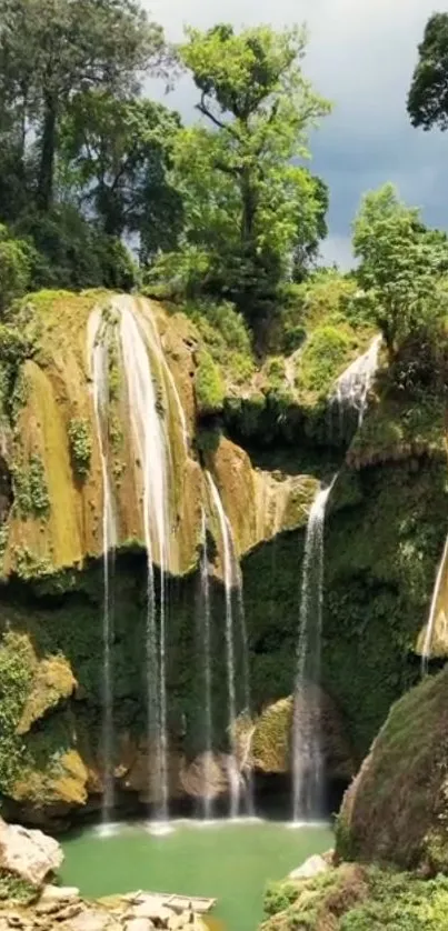 Serene waterfall flowing in lush green jungle landscape.