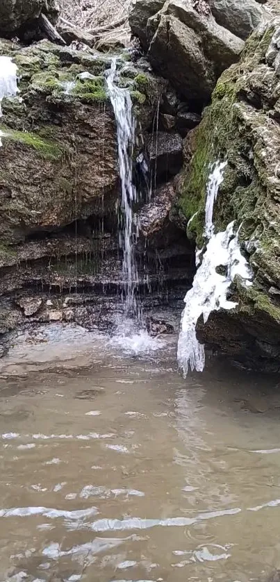 Peaceful waterfall over mossy rocks in nature scene.