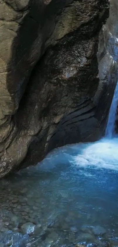 Waterfall gently cascading through rocky cave.