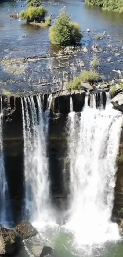 Cascading waterfall with lush greenery and rocks in a serene landscape.