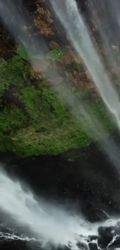 Serene mobile wallpaper with a lush waterfall and greenery.