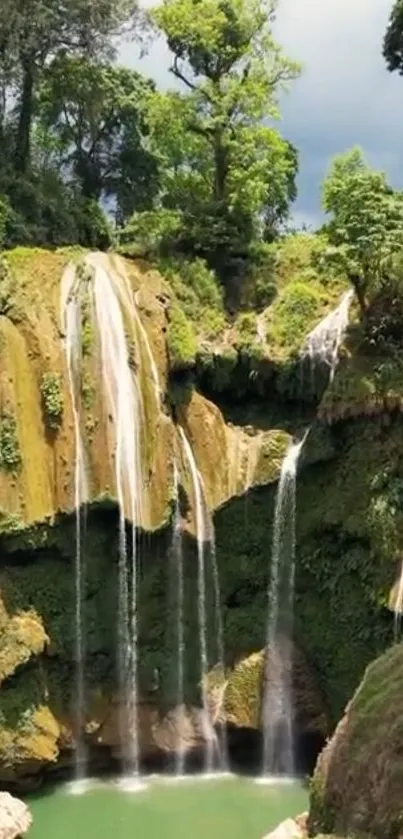 Serene waterfall in lush green landscape, perfect for nature lovers' mobile wallpaper.