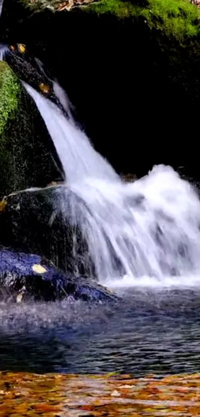 Serene waterfall cascading down mossy rocks into a tranquil pool.