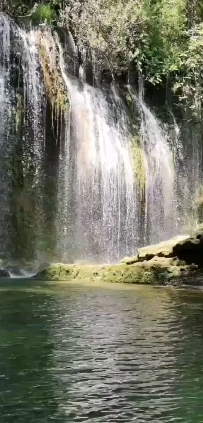 Serene waterfall with lush greenery and tranquil waters.