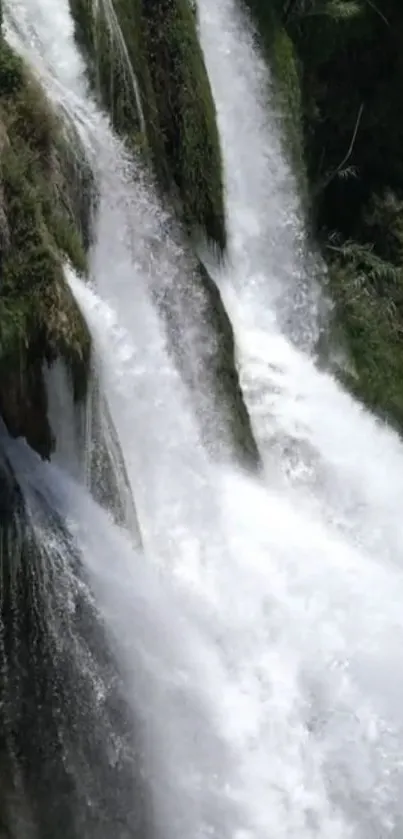 Serene waterfall with cascading water and lush green surroundings.