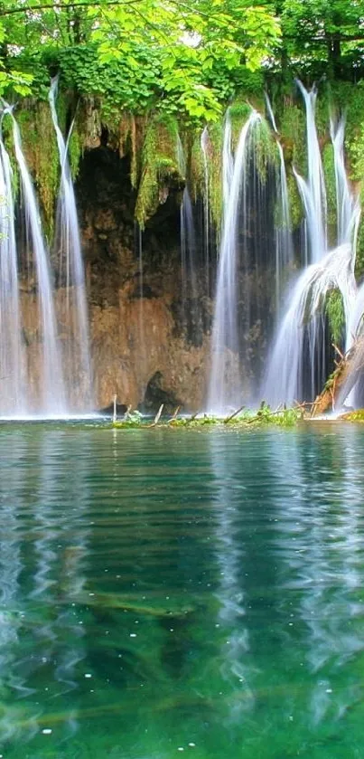 Serene waterfall with lush greenery and clear water reflection.