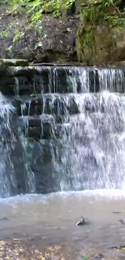 Serene waterfall cascading over stones with green foliage.