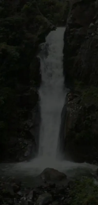 Serene waterfall with lush greenery background.