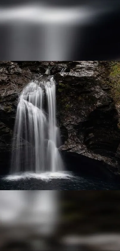 Serene waterfall flowing over rocky cliffs surrounded by lush greenery.