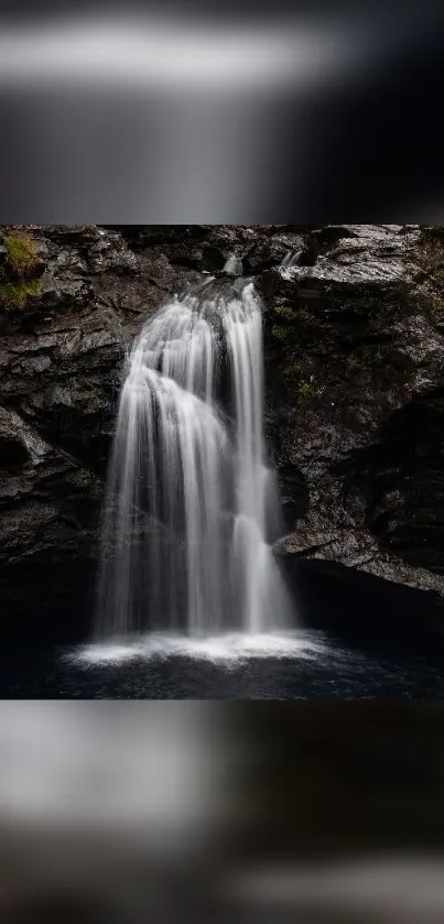 Serene waterfall cascading over rocks in a scenic mobile wallpaper.