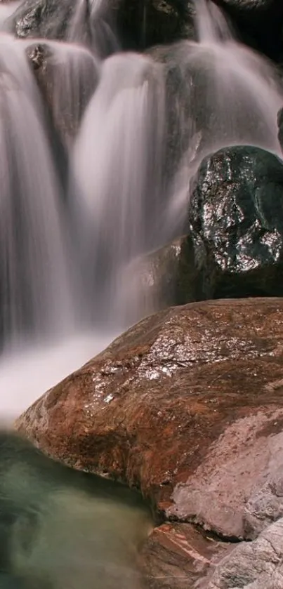 Serene waterfall cascading over rocks in soothing natural landscape.