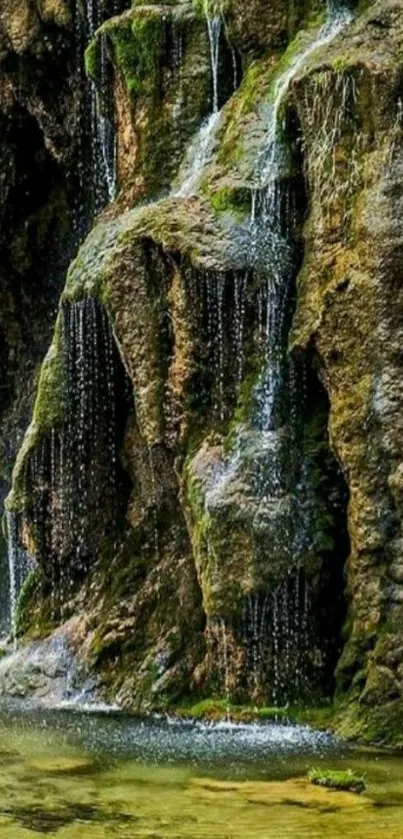 Serene waterfall wallpaper with mossy rocks and gentle water flow.