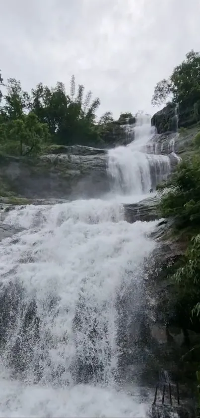 Serene waterfall with lush greenery and cascading water.