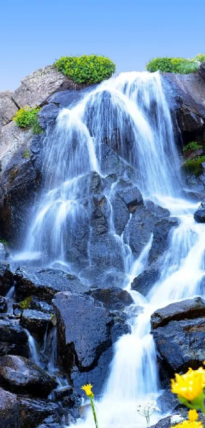 Serene waterfall cascading over rocks with vibrant flowers.