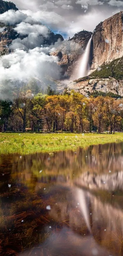 Serene waterfall in a lush valley with misty clouds and reflections.