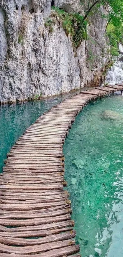 Wooden bridge over turquoise water by a waterfall