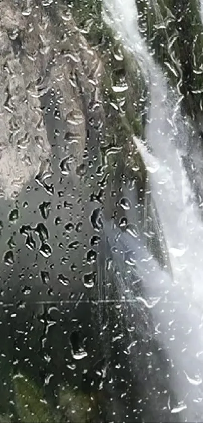 Wallpaper with raindrops and a waterfall on a window, creating a serene atmosphere.