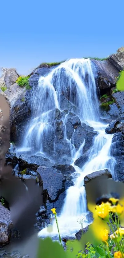 Serene waterfall with blue sky and flowers in mobile wallpaper.