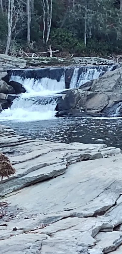 Serene waterfall with rocky landscape and calm waters.