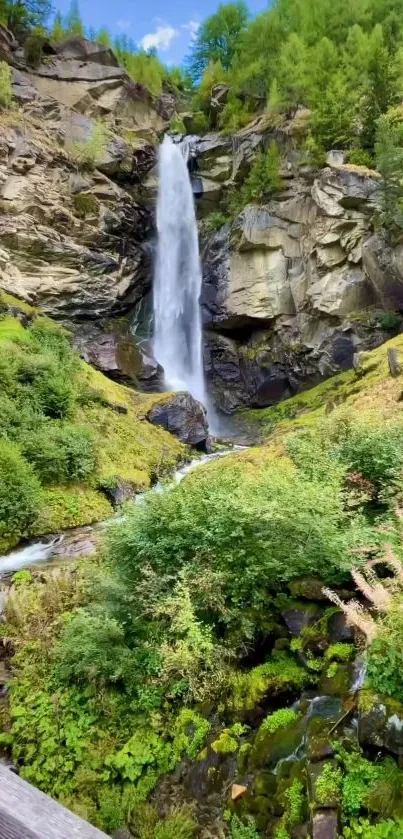 A serene waterfall cascades amid lush green forest and rocky cliffs.