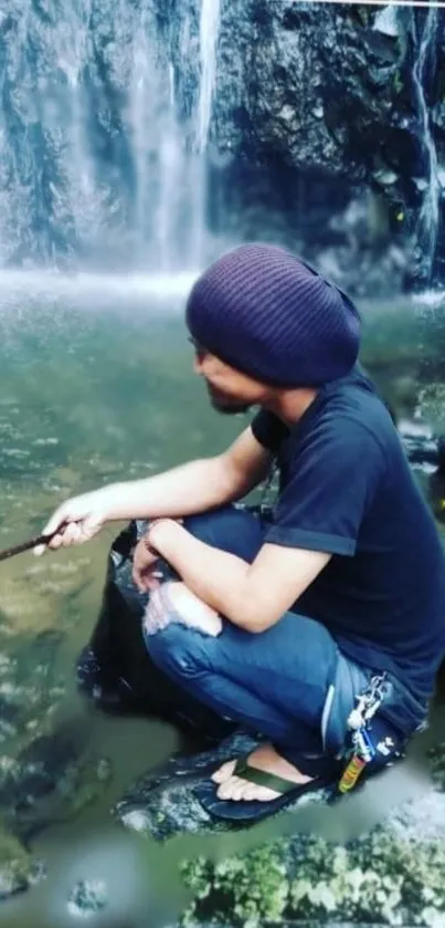 Person sitting near a tranquil waterfall in nature.