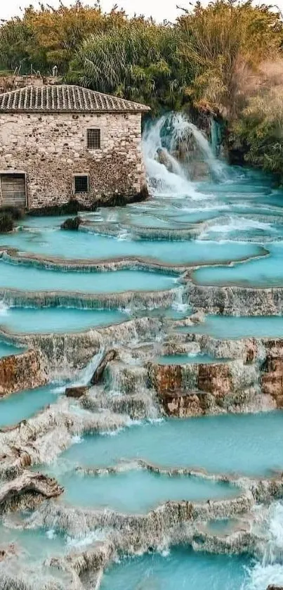 Serene cascading waterfall with turquoise water and rustic building.