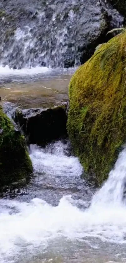 Waterfall with mossy rocks and flowing stream, nature wallpaper.