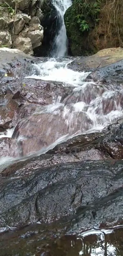 Serene waterfall stream flowing over rocks, offering a tranquil nature view.