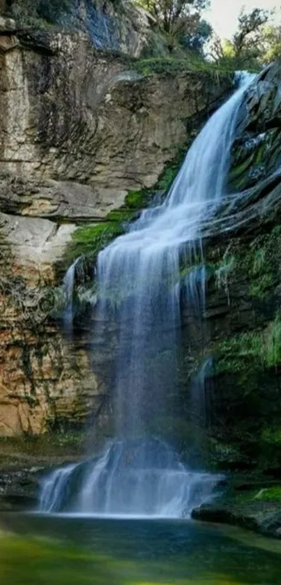 Serene cascading waterfall in lush greenery, ideal for mobile wallpaper.