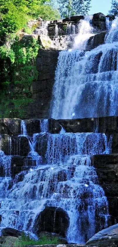 A serene waterfall cascading down rocks surrounded by lush greenery.