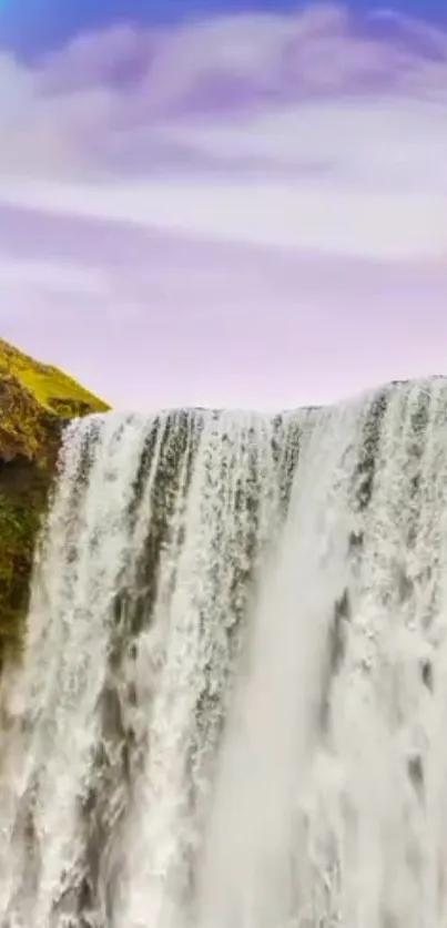 A serene waterfall cascades with a rainbow in the sky, offering a tranquil view.