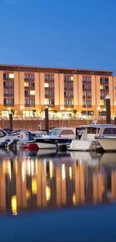 Serene waterfront view with boats and lit building at dusk.