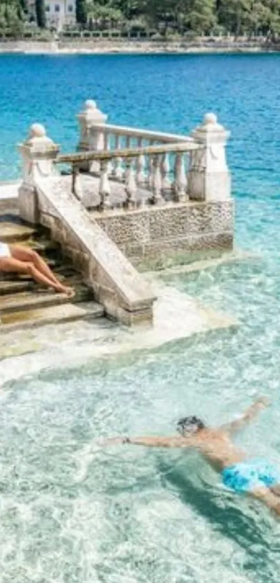 Woman relaxing by steps, swimmer in turquoise sea.