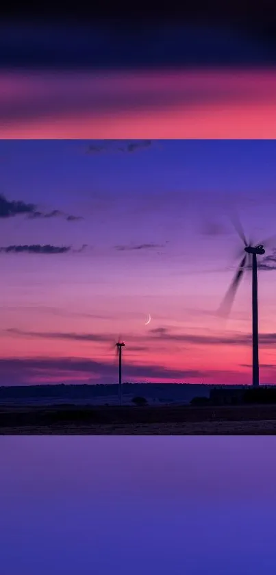 Scenic sunset with wind turbines in tranquil purple hues.