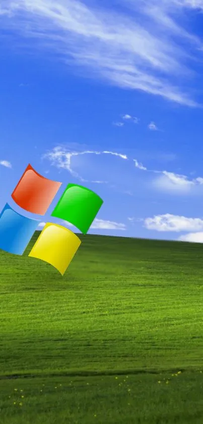 A lush green hill under a vibrant blue sky with a Windows logo.