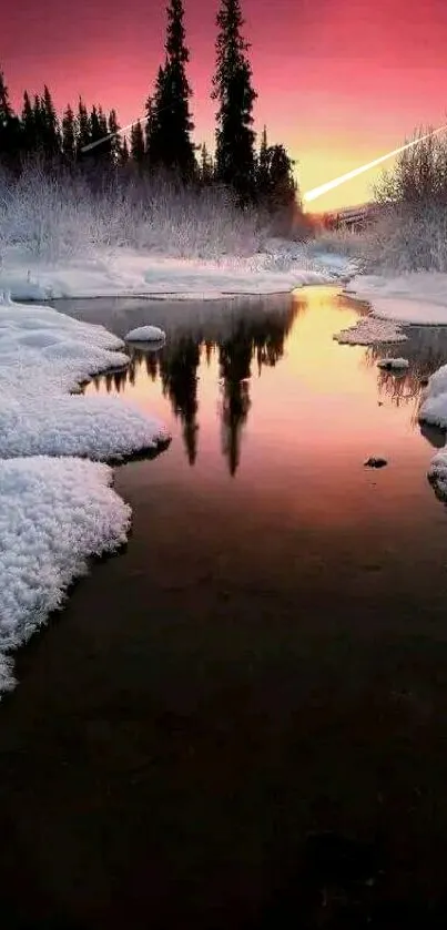 Winter creek at sunset with pink sky reflection.