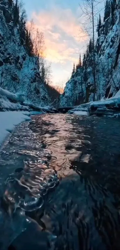 Winter stream flowing under vibrant sunset sky.