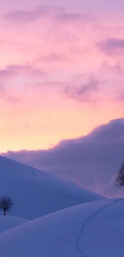 Peaceful snow-covered hills at sunrise with silhouetted trees against a pink sky.