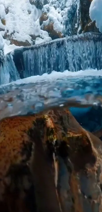 Serene waterfall in winter with snowy landscape.