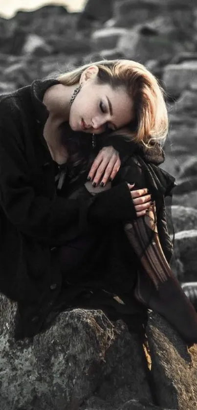 Serene woman sitting on rocks by the shore, tranquil and reflective.