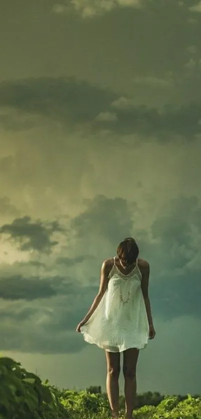 Woman in white dress stands under stormy sky with dramatic clouds.