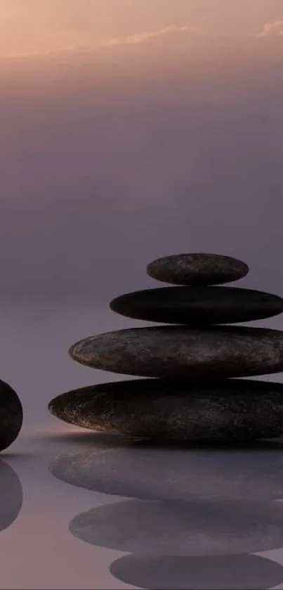 Serene zen stones stacked against a purple sunset sky.