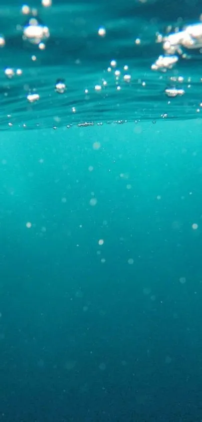 Serene underwater view with bubbles in teal blue sea.