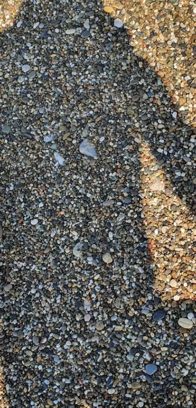 Shadow cast on a pebble beach, creating an artistic mobile wallpaper design.