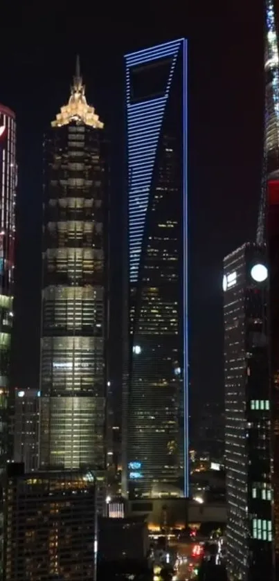 Shanghai skyscrapers glowing under night sky.