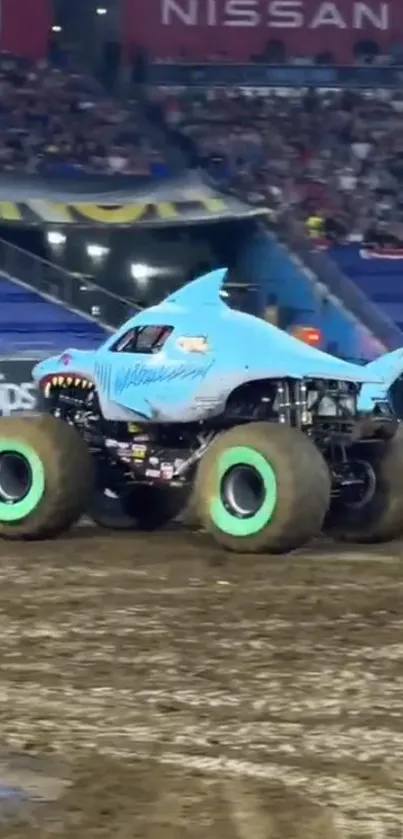 Shark-themed monster truck in action during an intense arena event.