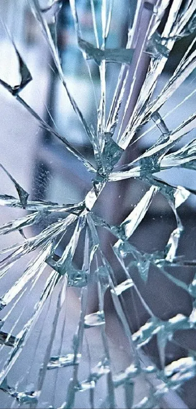 Shattered glass artwork with blue shades on phone wallpaper.