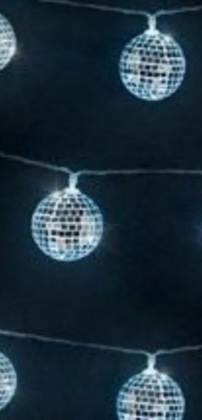 Disco balls on string lights against a dark backdrop.