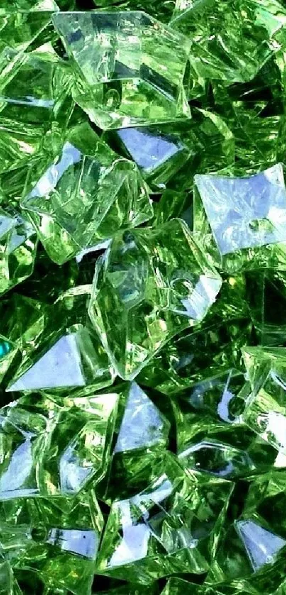 Shimmering green gem crystals on a vibrant wallpaper background.